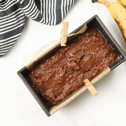 Loaf pan with chocolate banana bread batter.