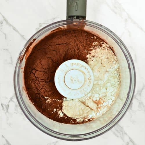 No-bake brownie ingredients in the bowl of a food processor.