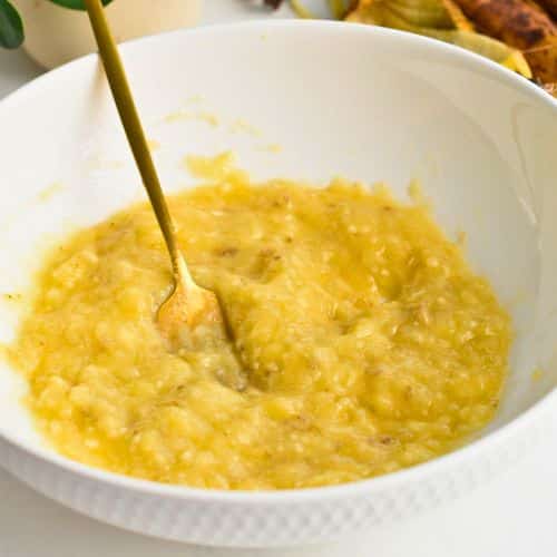 Mashed bananas in a mixing bowl.