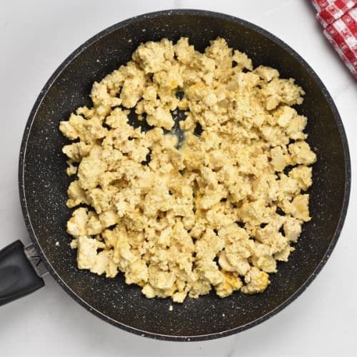 Tofu scramble ready to cook in a skillet.