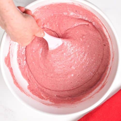 Vegan strawberry cake batter ready and mixed in a large mixing bowl.