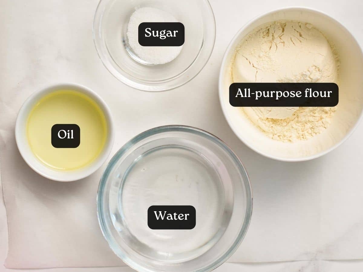 A picture of bowls filled with water, oil, sugar and flour to make churros.