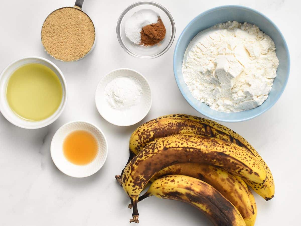 Ingredients for Eggless Banana Bread in bowls and ramekins.