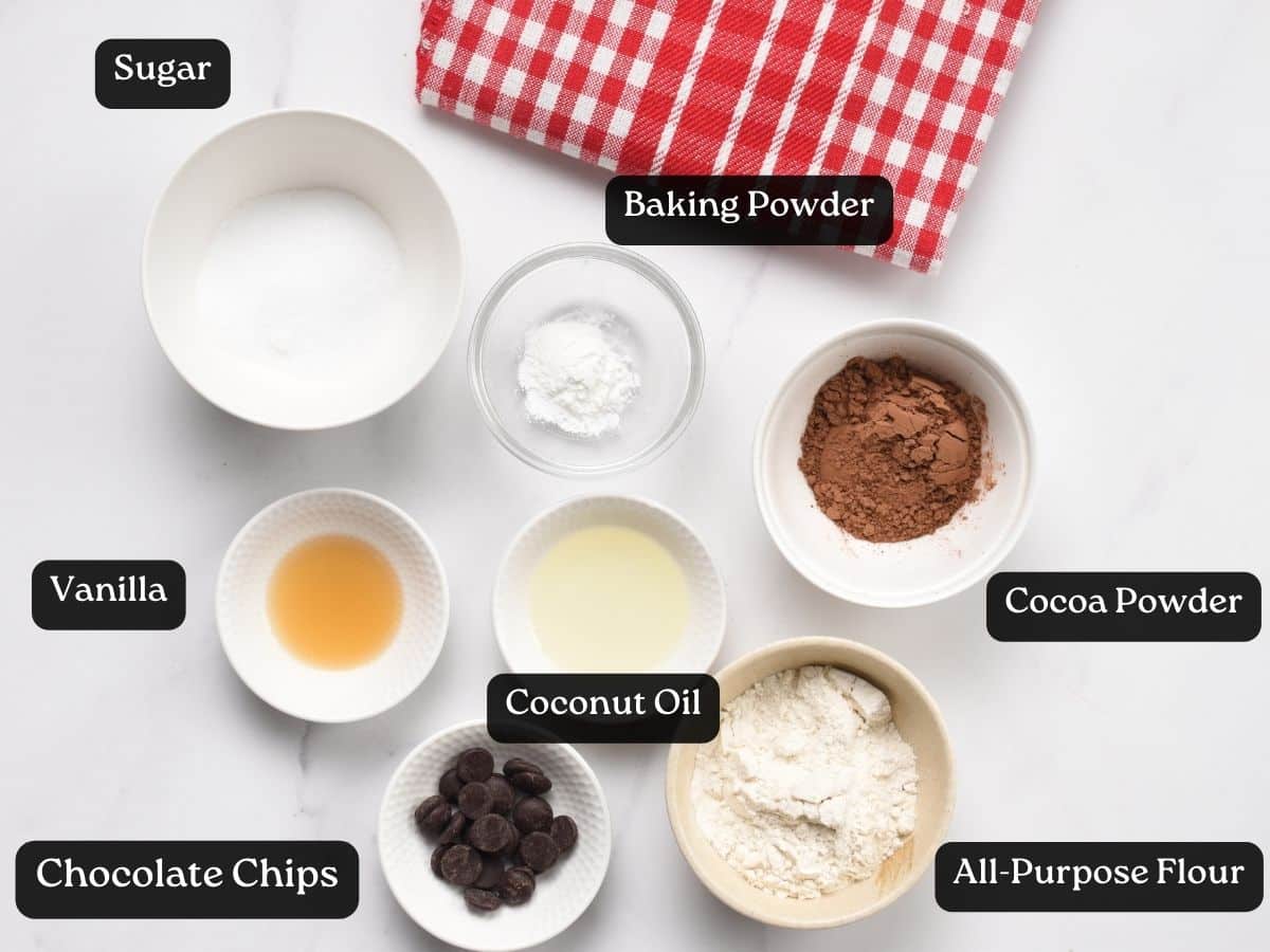 Ingredients for Gooey Chocolate Mug Cake in bowls and ramekins.