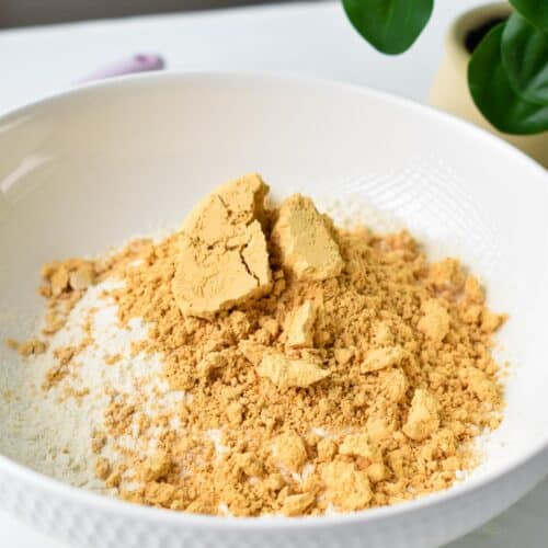 a mixing bowl filled with powdered peanut butter and self-rising flour