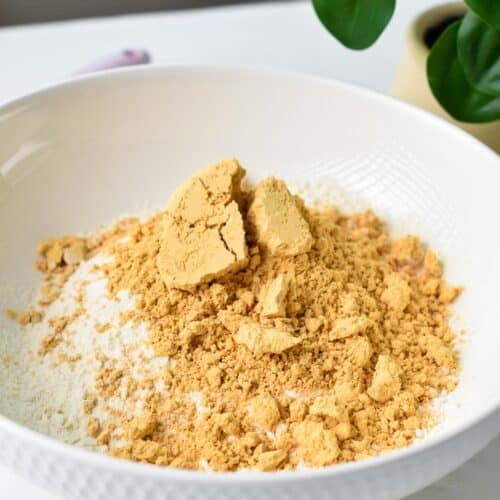 a mixing bowl filled with powdered peanut butter and self-rising flour