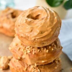 a stack of three peanut butter donuts with peanut butter glaze