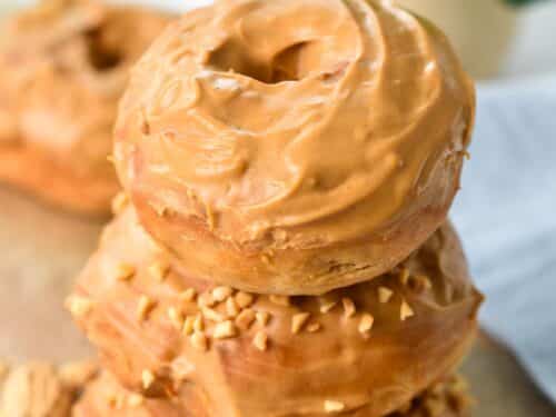 a stack of three peanut butter donuts with peanut butter glaze