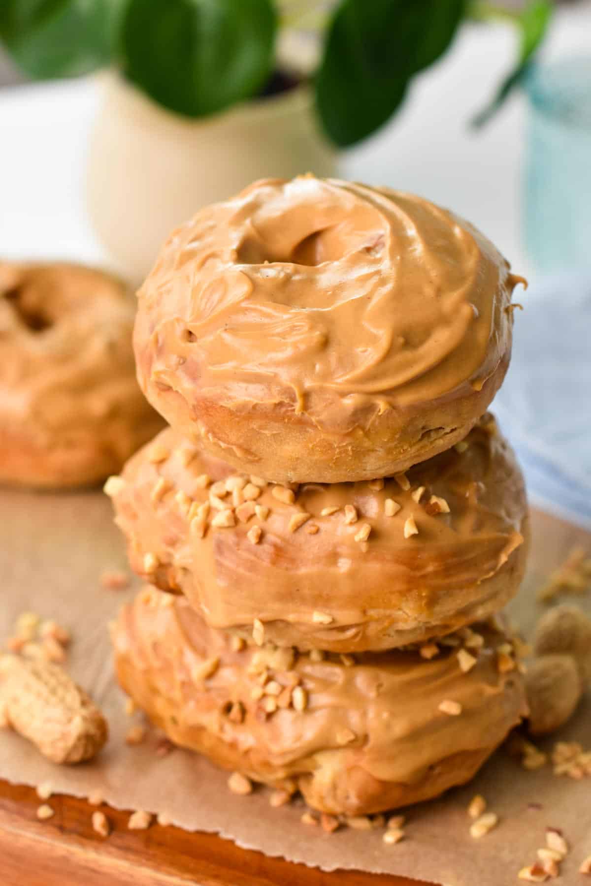 A stack of three peanut butter donuts with peanut butter glaze.