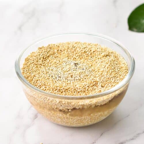 a bowl with white quinoa soaked in water