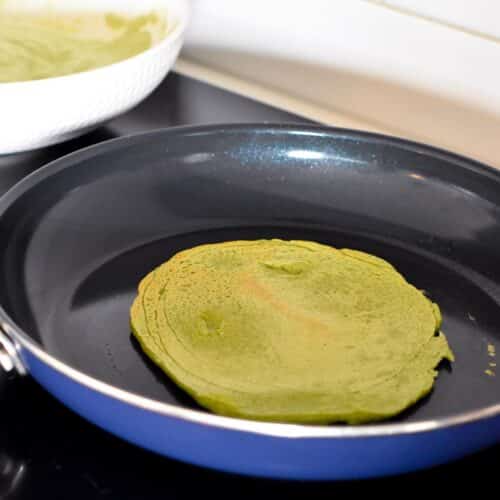 a green quinoa tortillas cooking in a pan