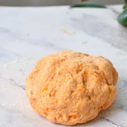 Sweet Potato Bread dough rolled into a large ball.