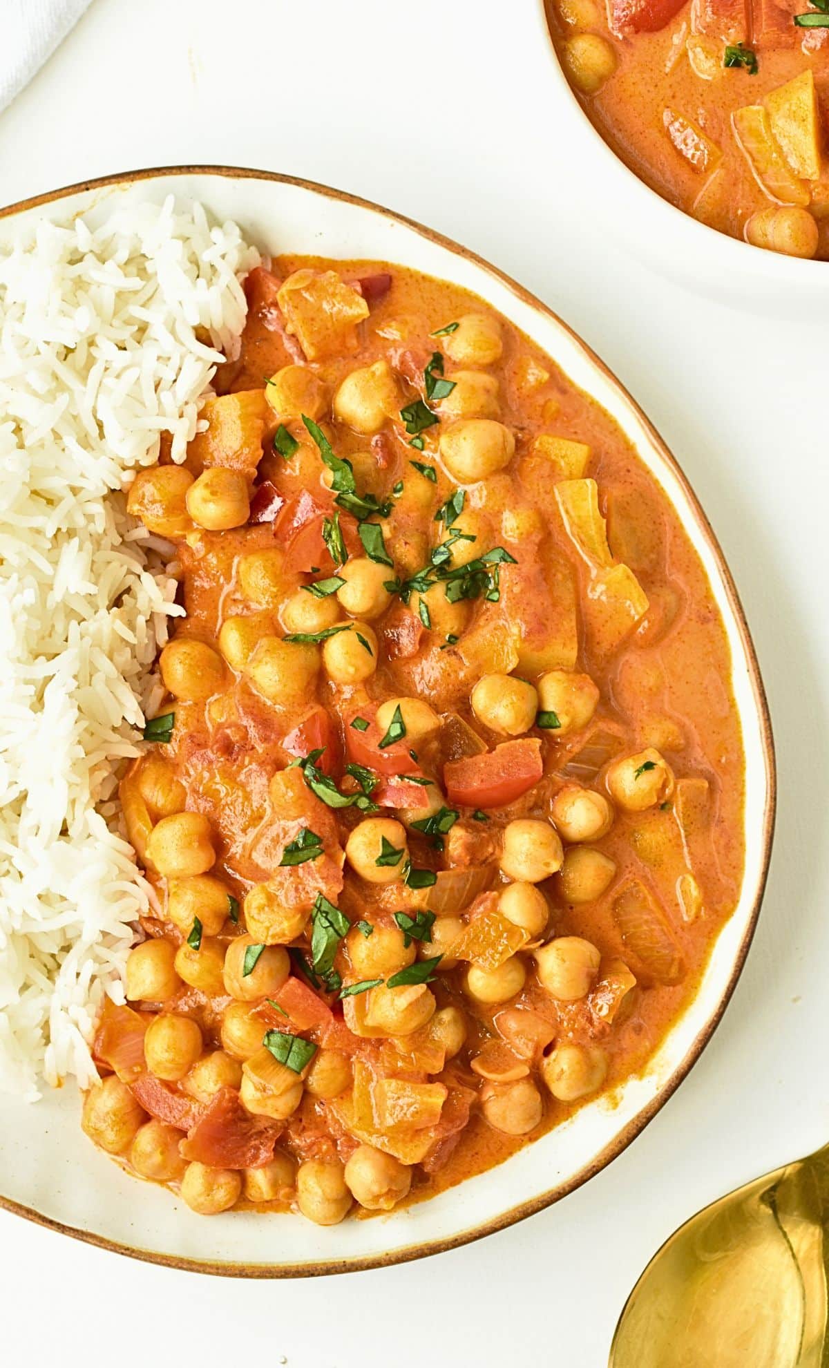Vegan chickpea curry on a plate with rice.