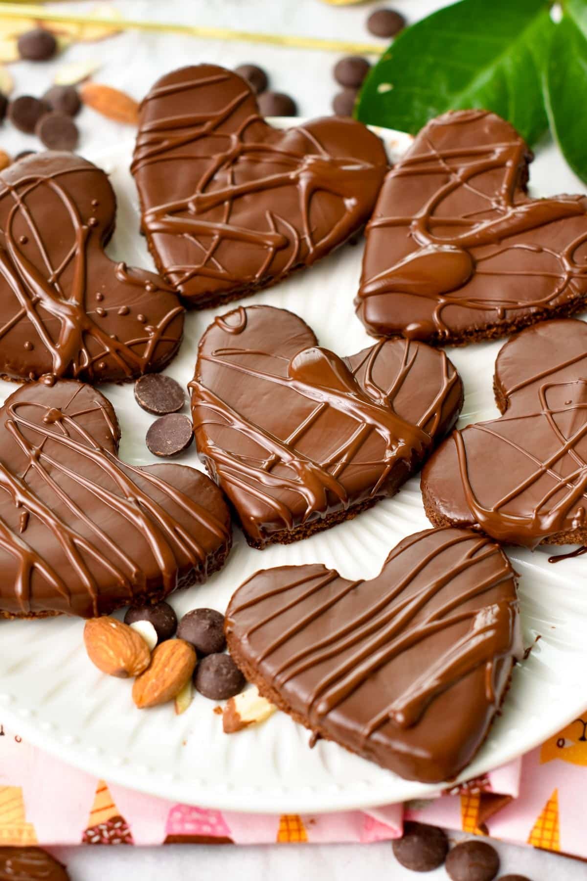 Heart shaped almond flour shortbread cookies covered with melted dark chocolate