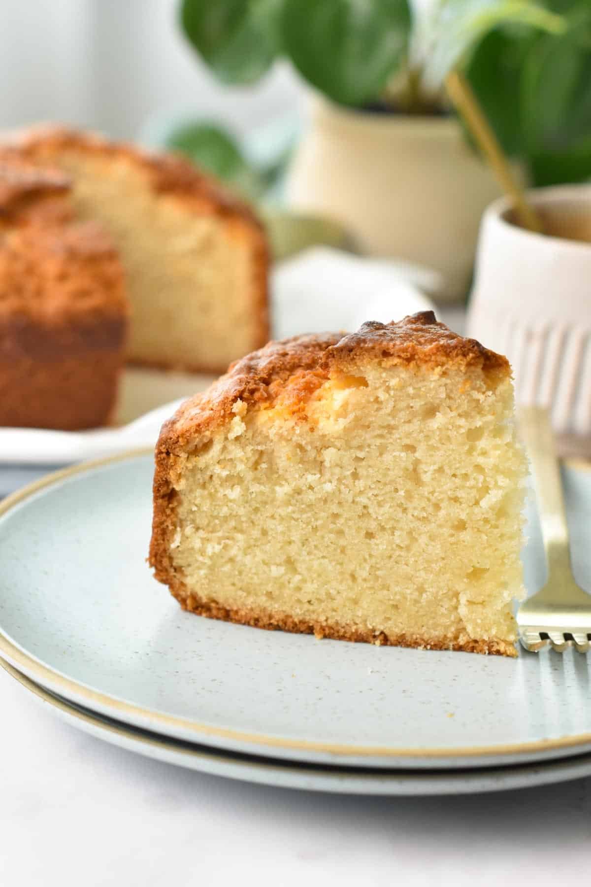 Slice of 4-ingredient Yogurt Cake on a plate with a golden fork.
