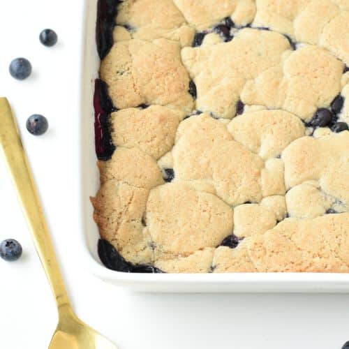 Vegan blueberry cobbler baked on a ceramic pan.