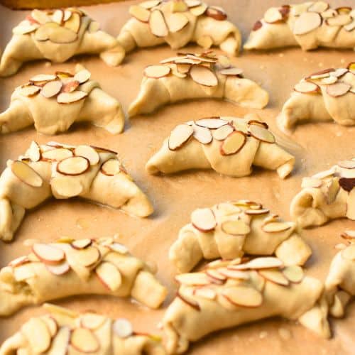 Almond Croissant Pastry ready to be baked on a baking sheet.