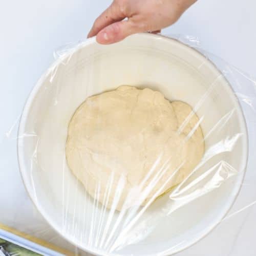Wrapping a bowl with spelt pizza dough.