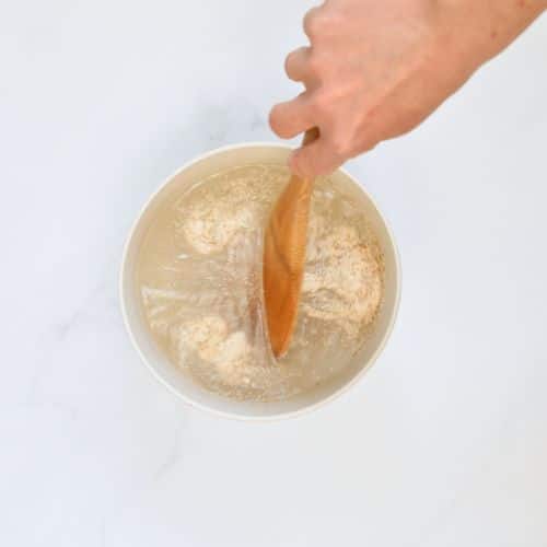 Activating yeast in a small bowl.