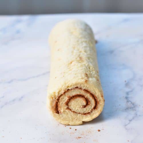 Rolled Yeast-Free Cinnamon Rolls dough on a benchtop.