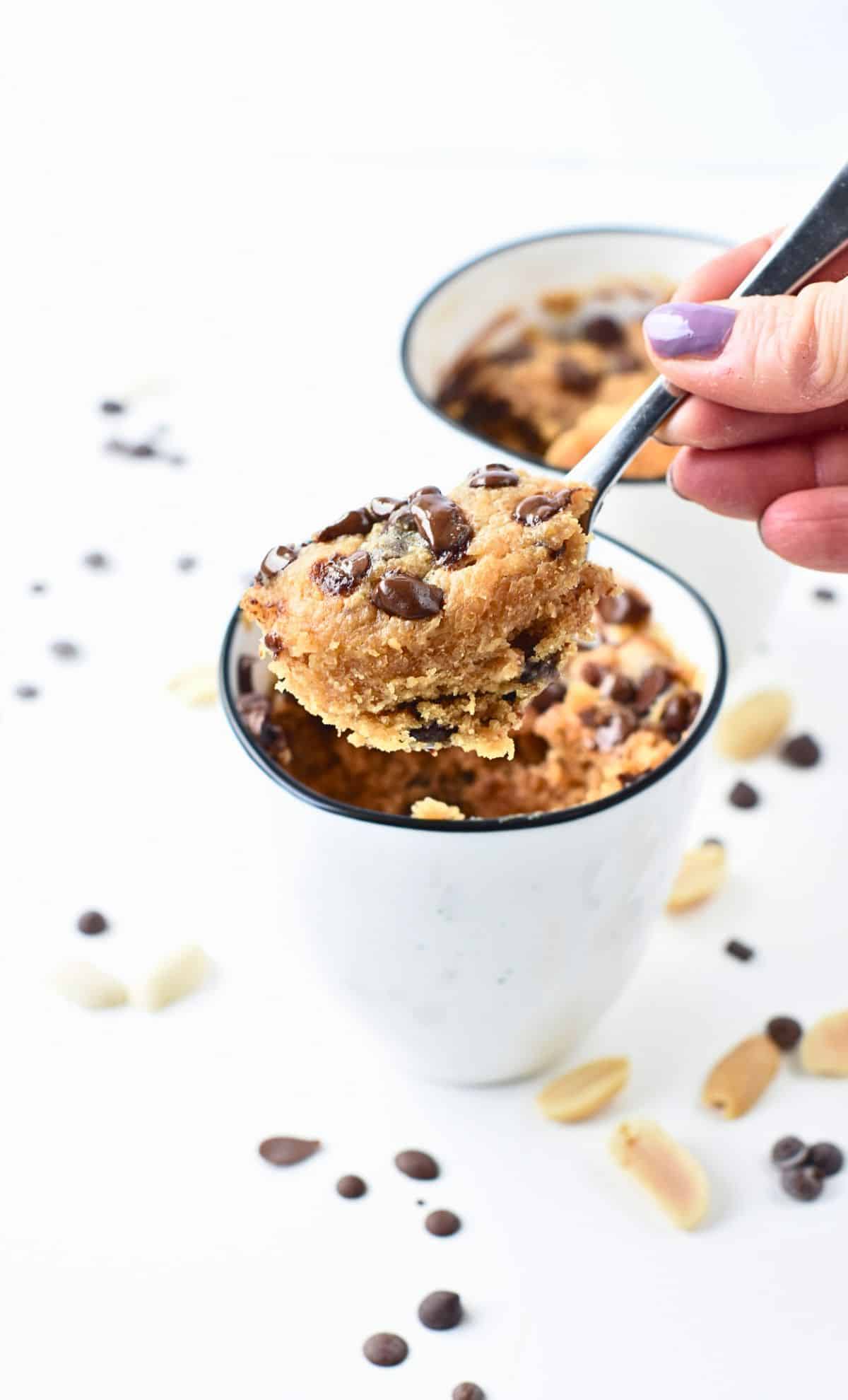 Spoon taking a portion of Peanut Butter Mug Cake.