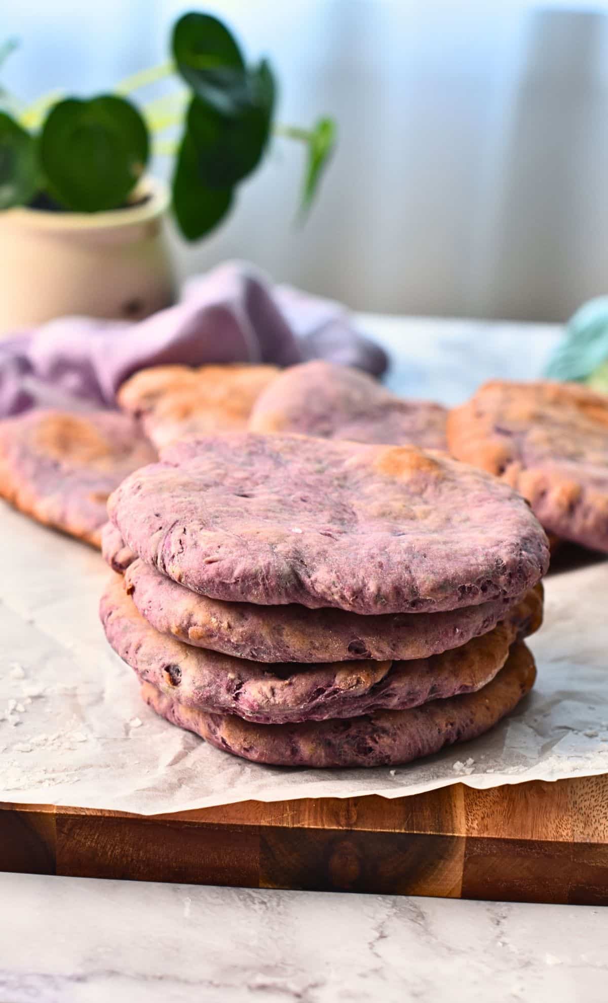 Purple Sweet Potato Pita stacked on baking paper.