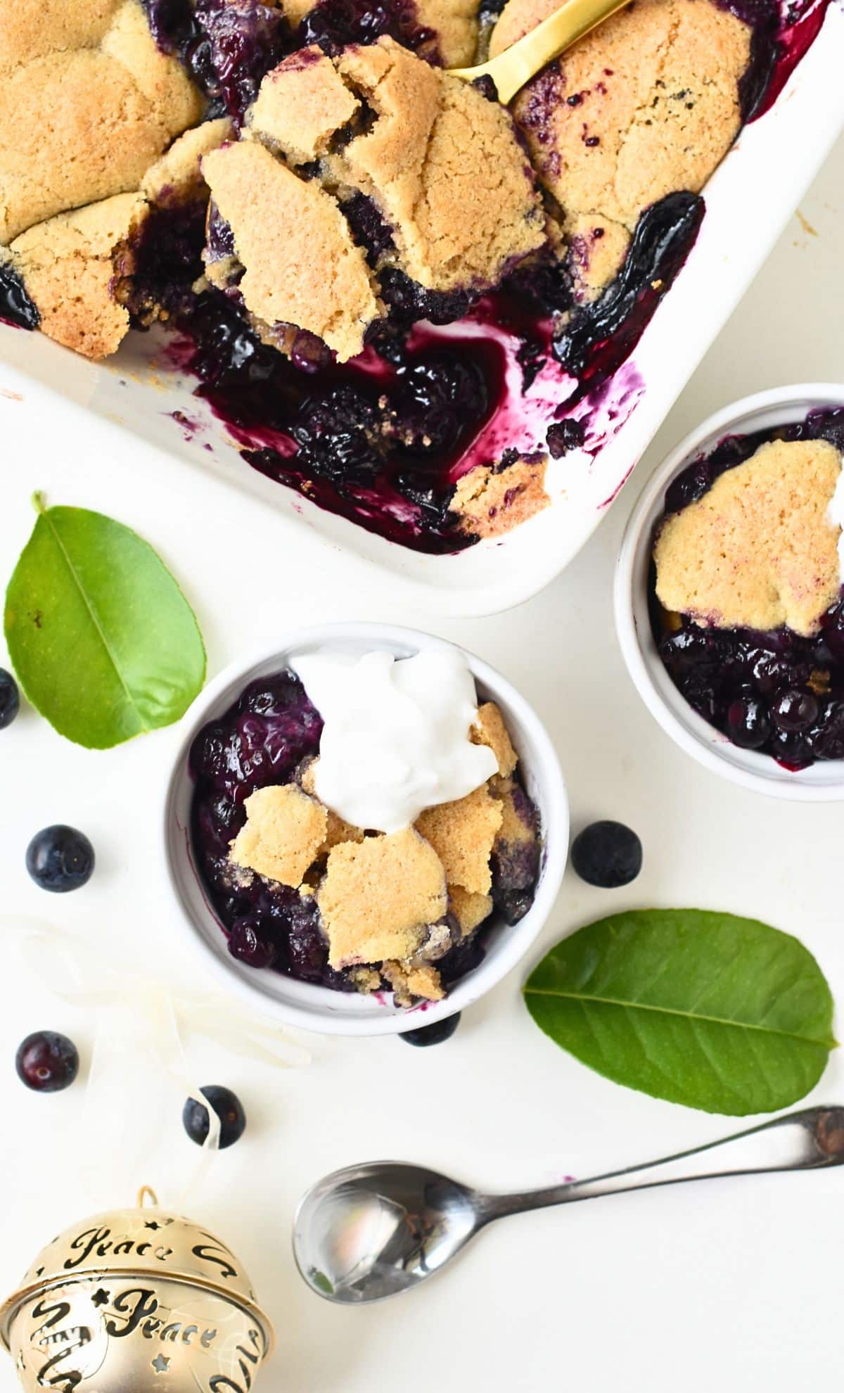 Vegan blueberry cobbler served in two small ramekins.