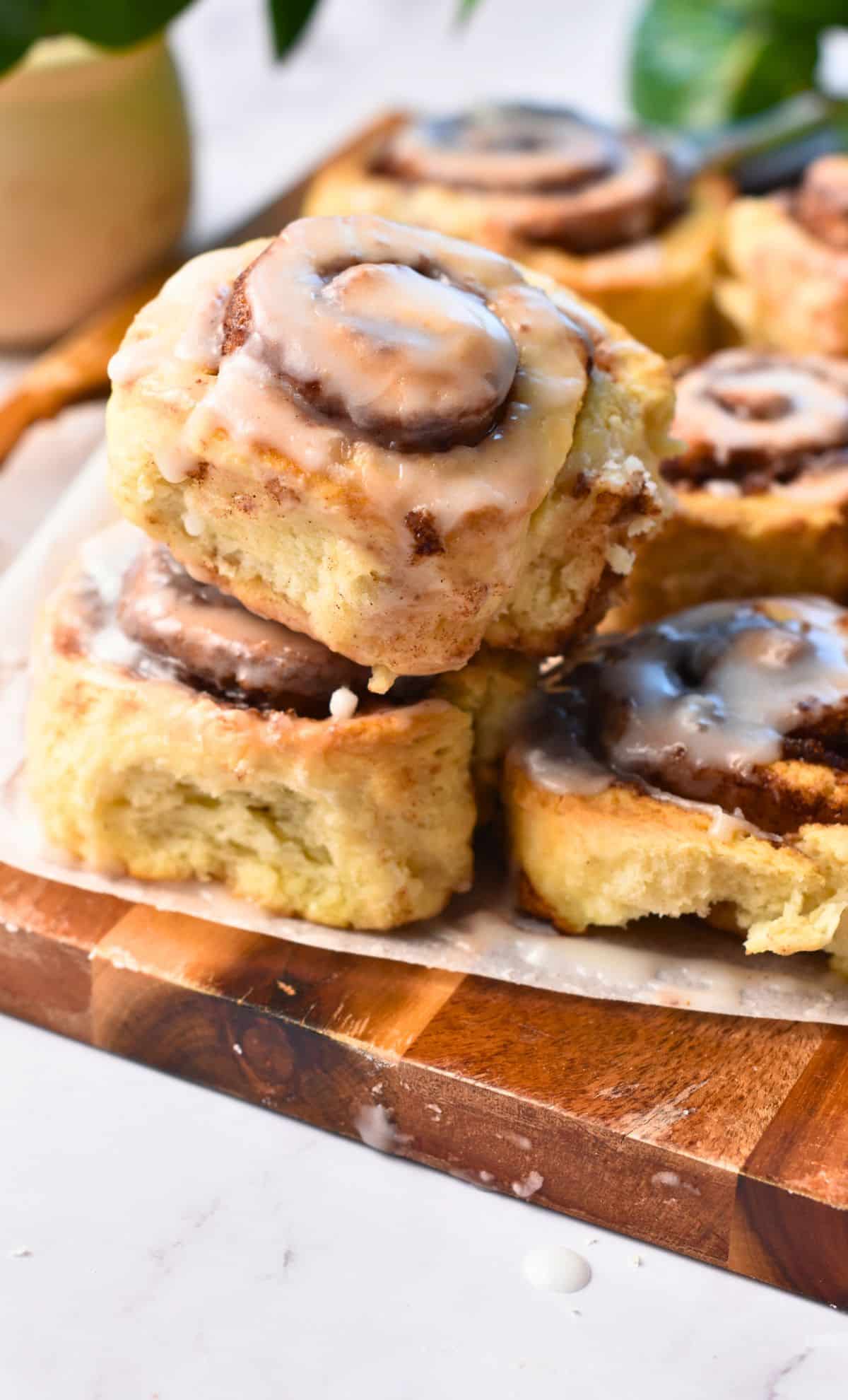 Yeast-Free Cinnamon Rolls stacked on a wooden board.
