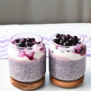 Blueberry Protein Overnight Oats in three jars.