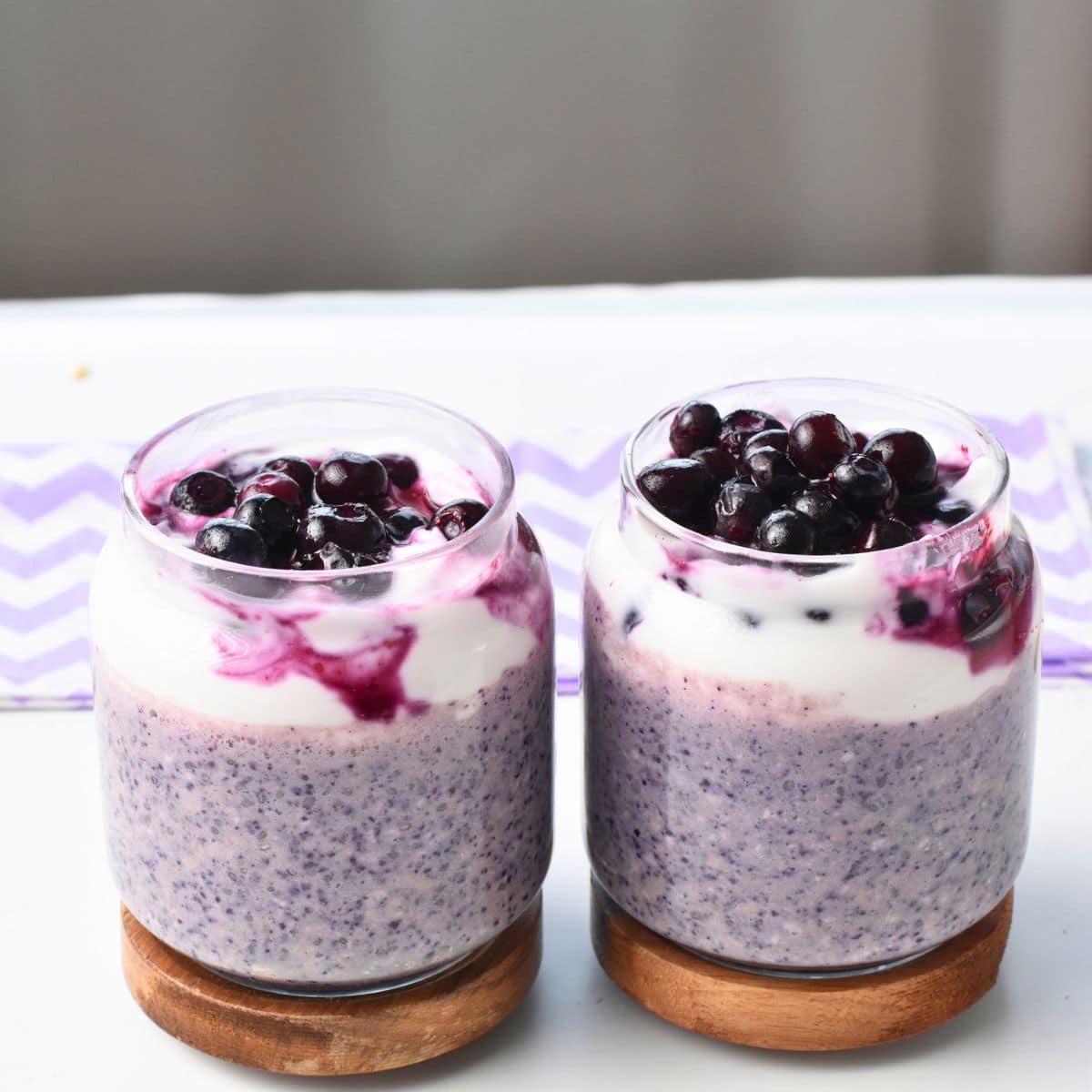 Blueberry Protein Overnight Oats in three jars.