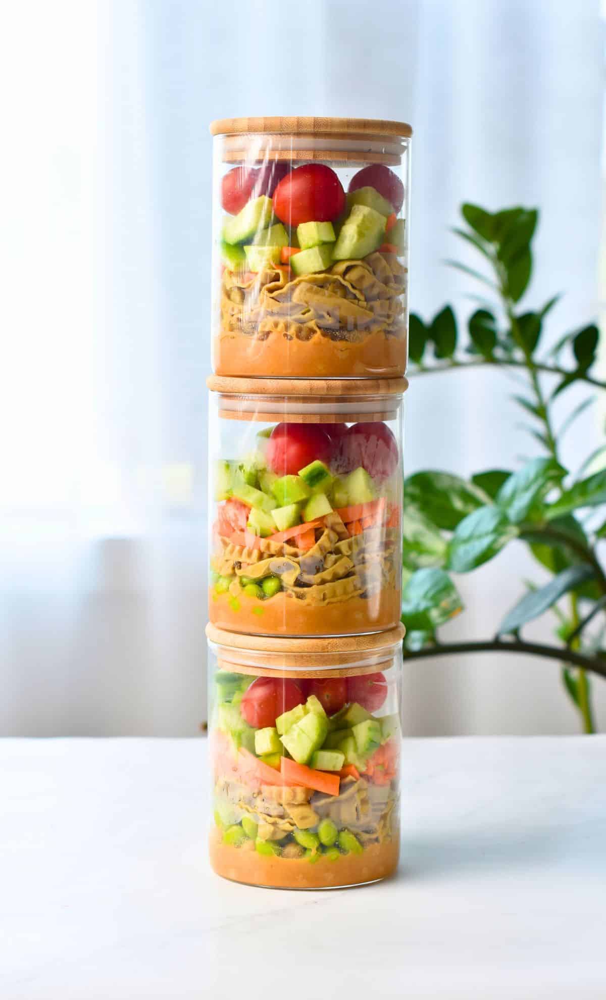 High Protein Vegan Salad in small jars stacked on one another.