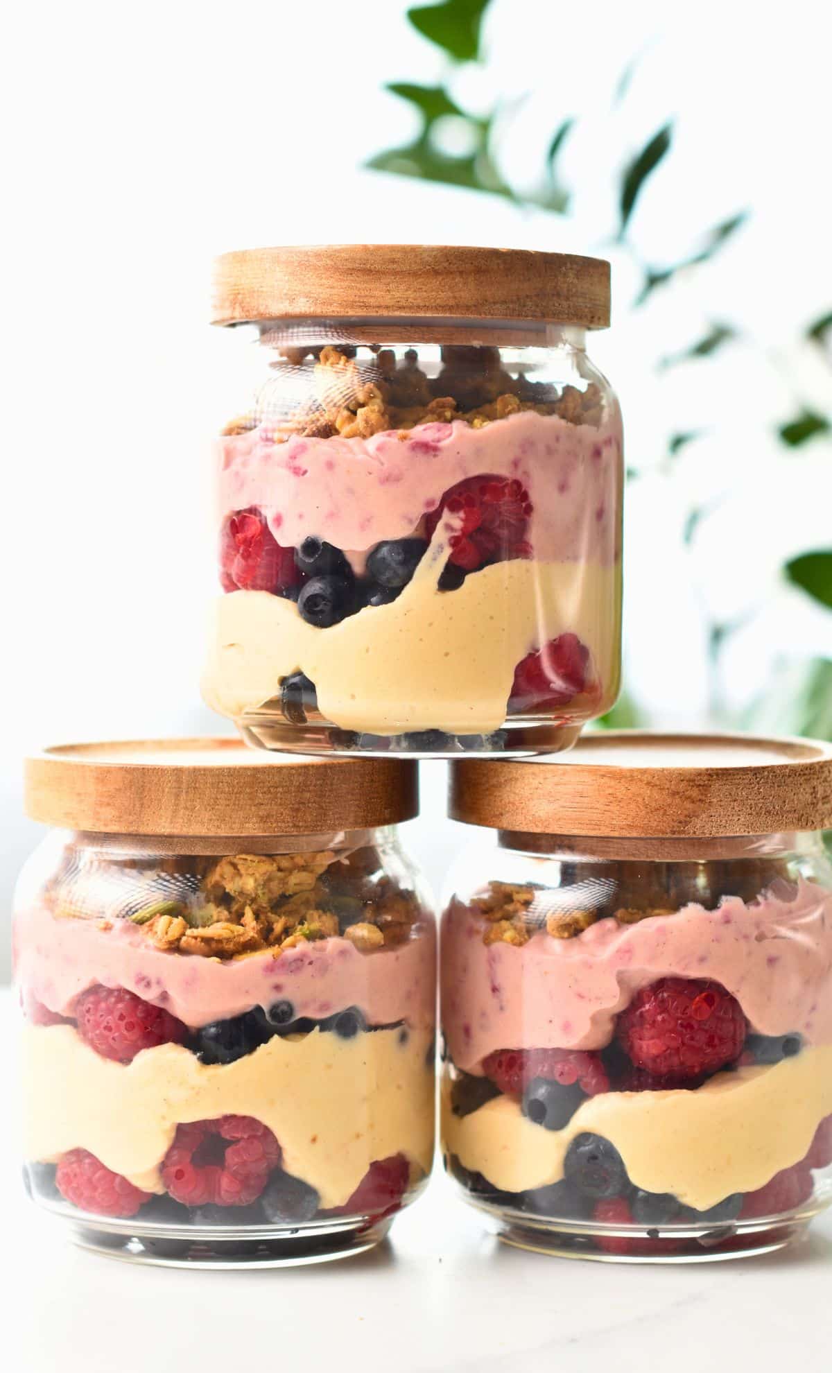 High Protein Yogurt Parfait in three jars stacked