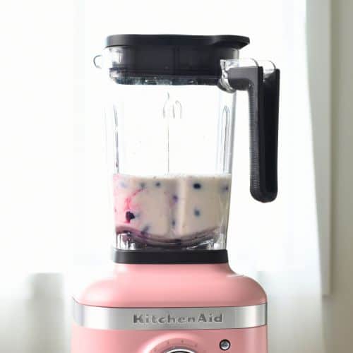 Preparing the blueberry milk in a blender.