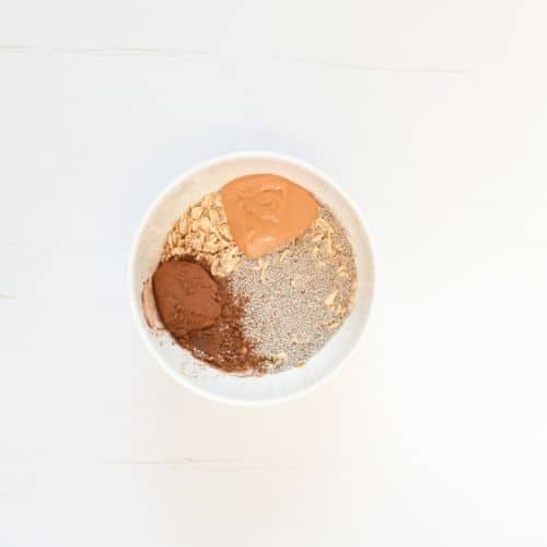 Combining Chocolate Overnight Oats in a small bowl.