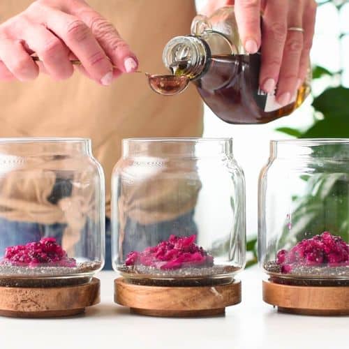 Mixing chia pudding base ingredients in small jars.