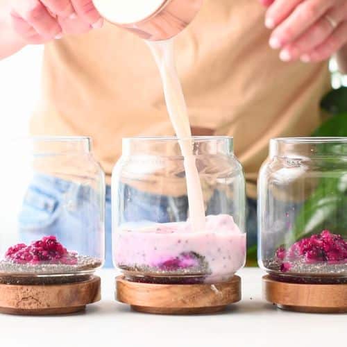 Adding milk to the chia pudding base.