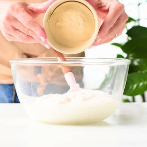 Mixing plant-based yogurt and protein powder.