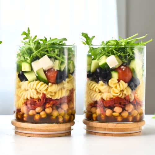 Pasta Salad With Balsamic Dressing in three glass jars.