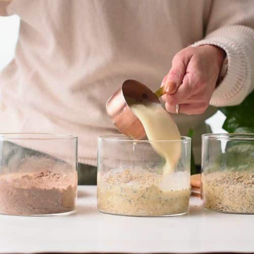 Pouring milk on the oats and chia seeds mix.
