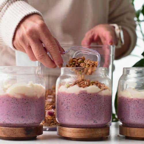 Adding granola on the chia pudding.