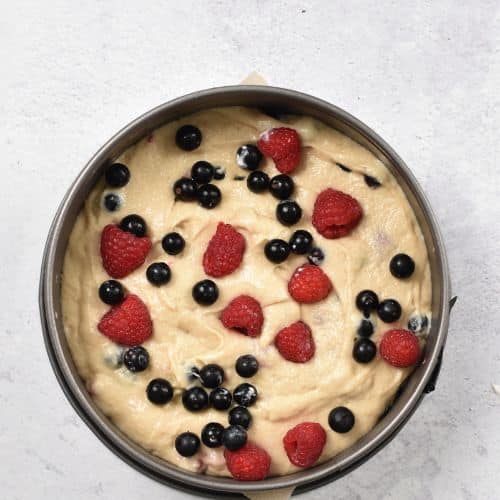 Adding fresh berries to the Yogurt Berry Cake