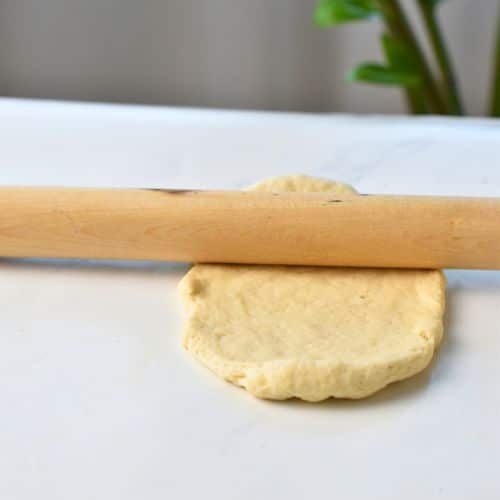 Flattened Yogurt Buns with a rolling pin