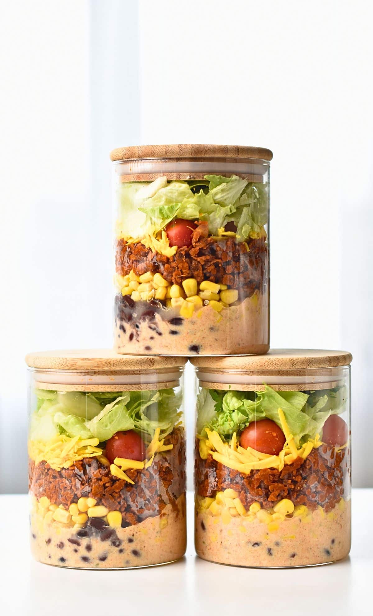 Vegan Taco Salad stacked in meal prep jars.