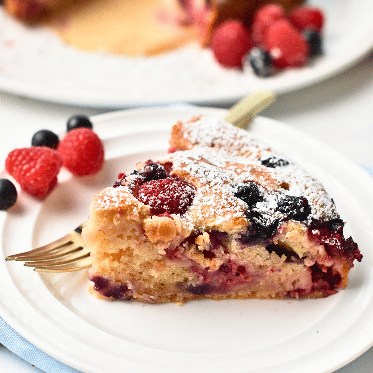 Slice of Yogurt Berry Cake on a white plate.