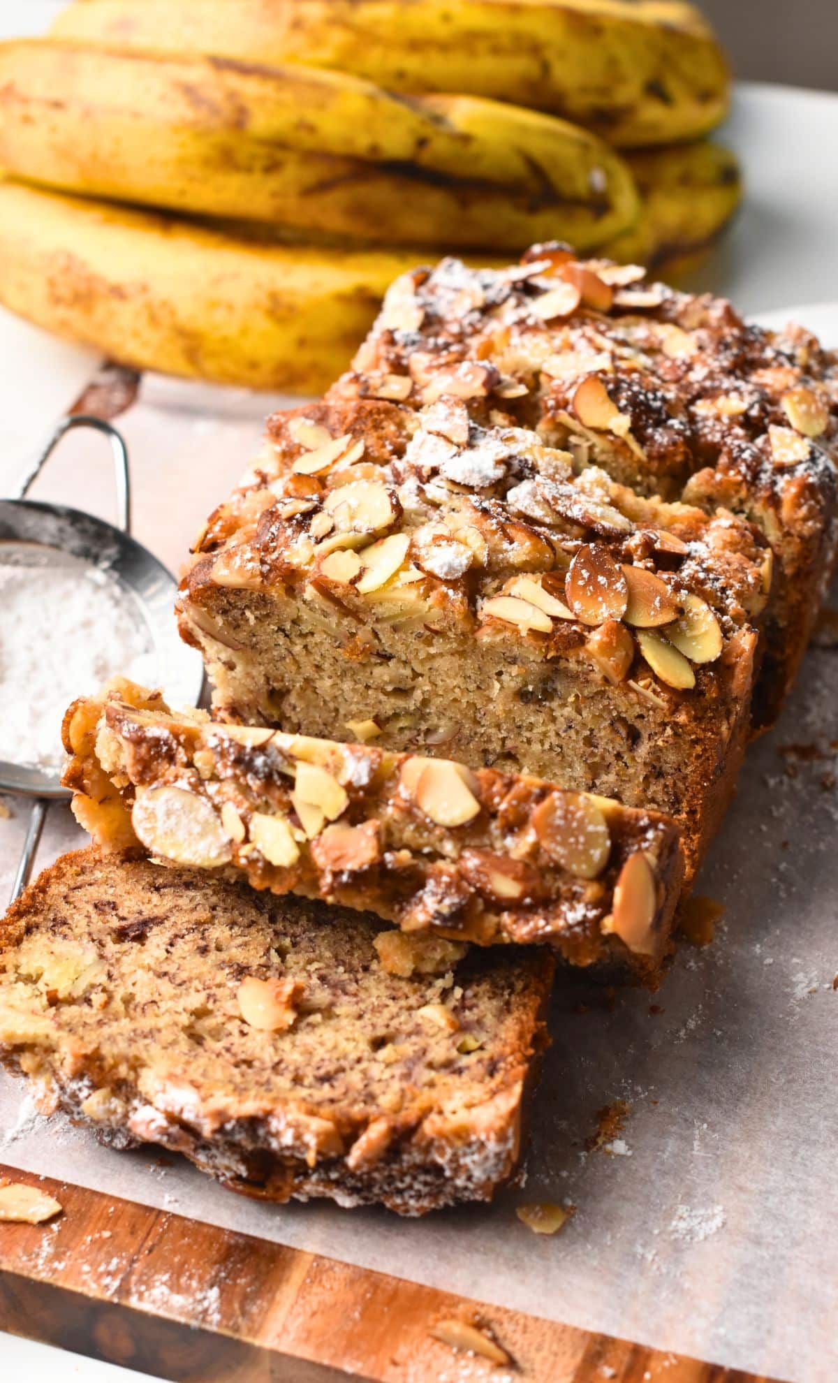Almond Banana Bread sliced next to a banana.