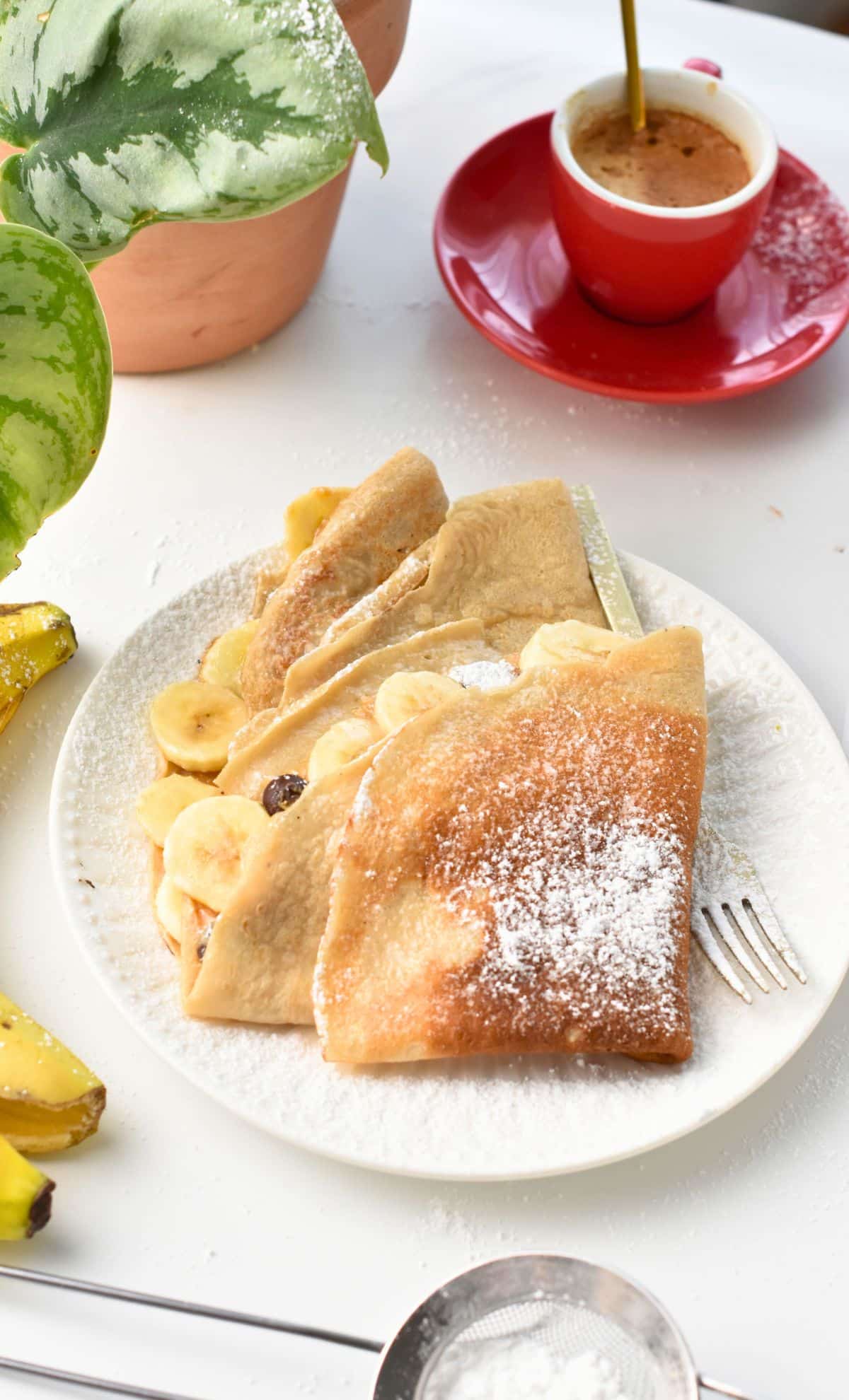 Banana Crepes folded in quarters and filled with bananas