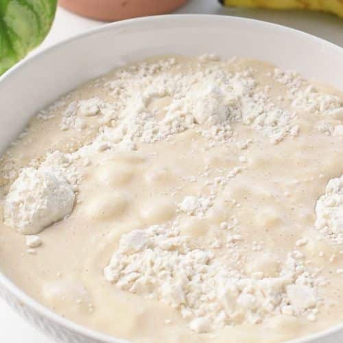 Combining banana milk and flour in a bowl