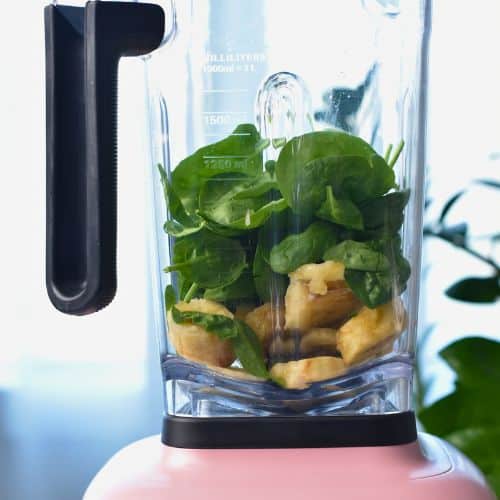 Combining Chocolate Peanut Butter Banana Smoothie ingredients in a blender.