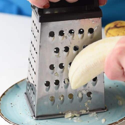 Shaving frozen bananas like cheese.