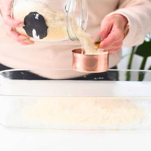 Pouring rice into a baking dish.